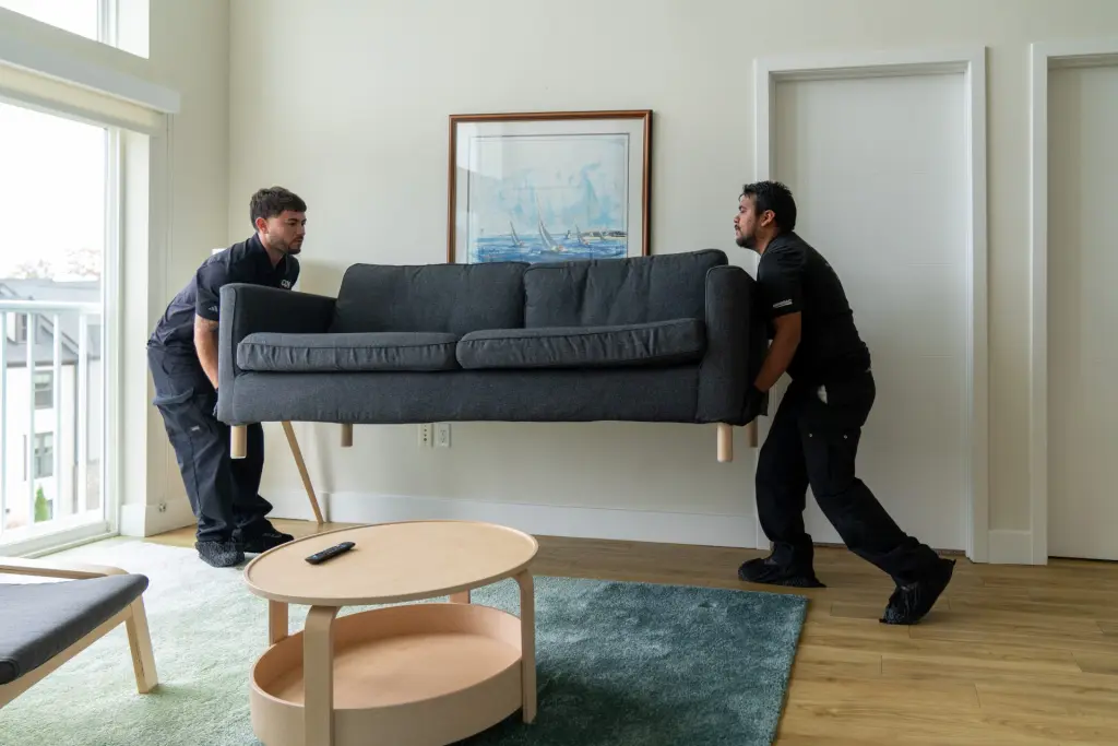 Two men delivering a couch