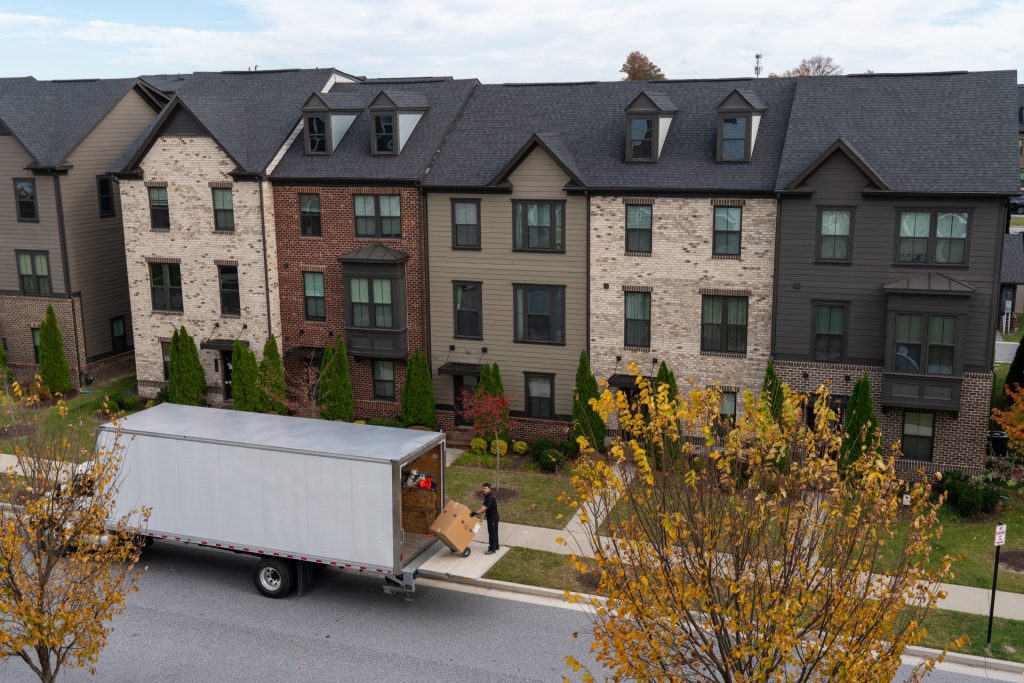 A truck delivering cabinets to a home