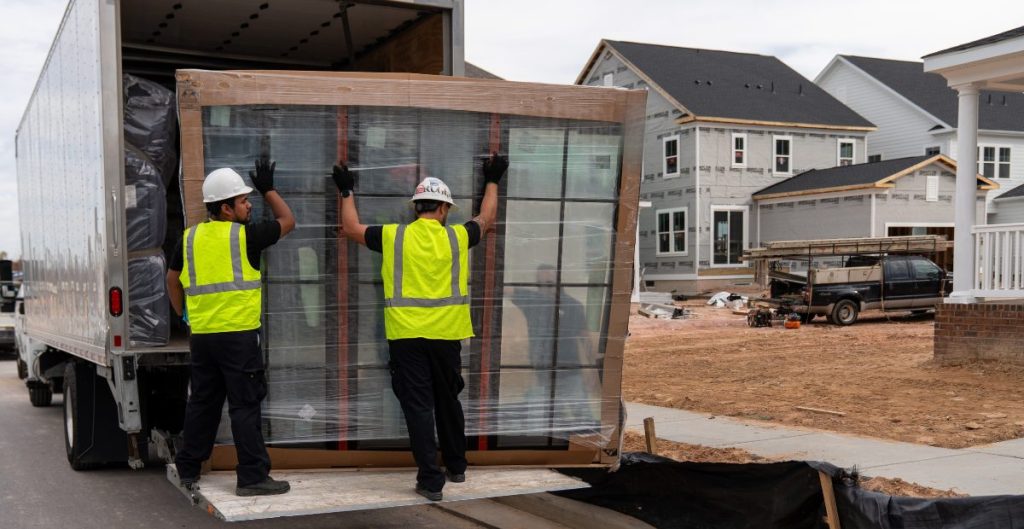 two men delivering French doors